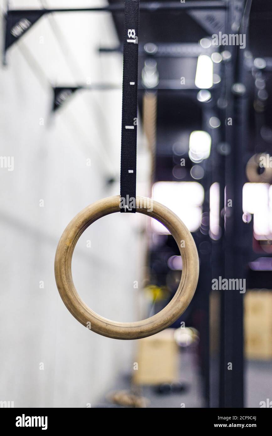 Gymnastic ring hanging in gym on blurred background Stock Photo - Alamy