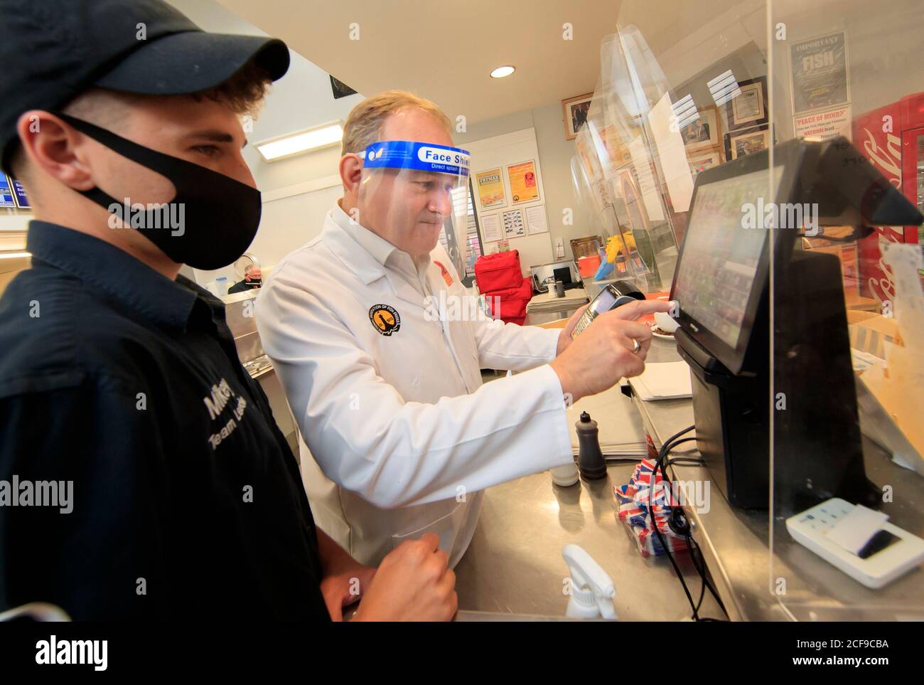 Liberal Democrat leader Ed Davey undertakes a 'shift' in Taylor's chip shop, in Stockport, during the start of his national listening tour. Stock Photo