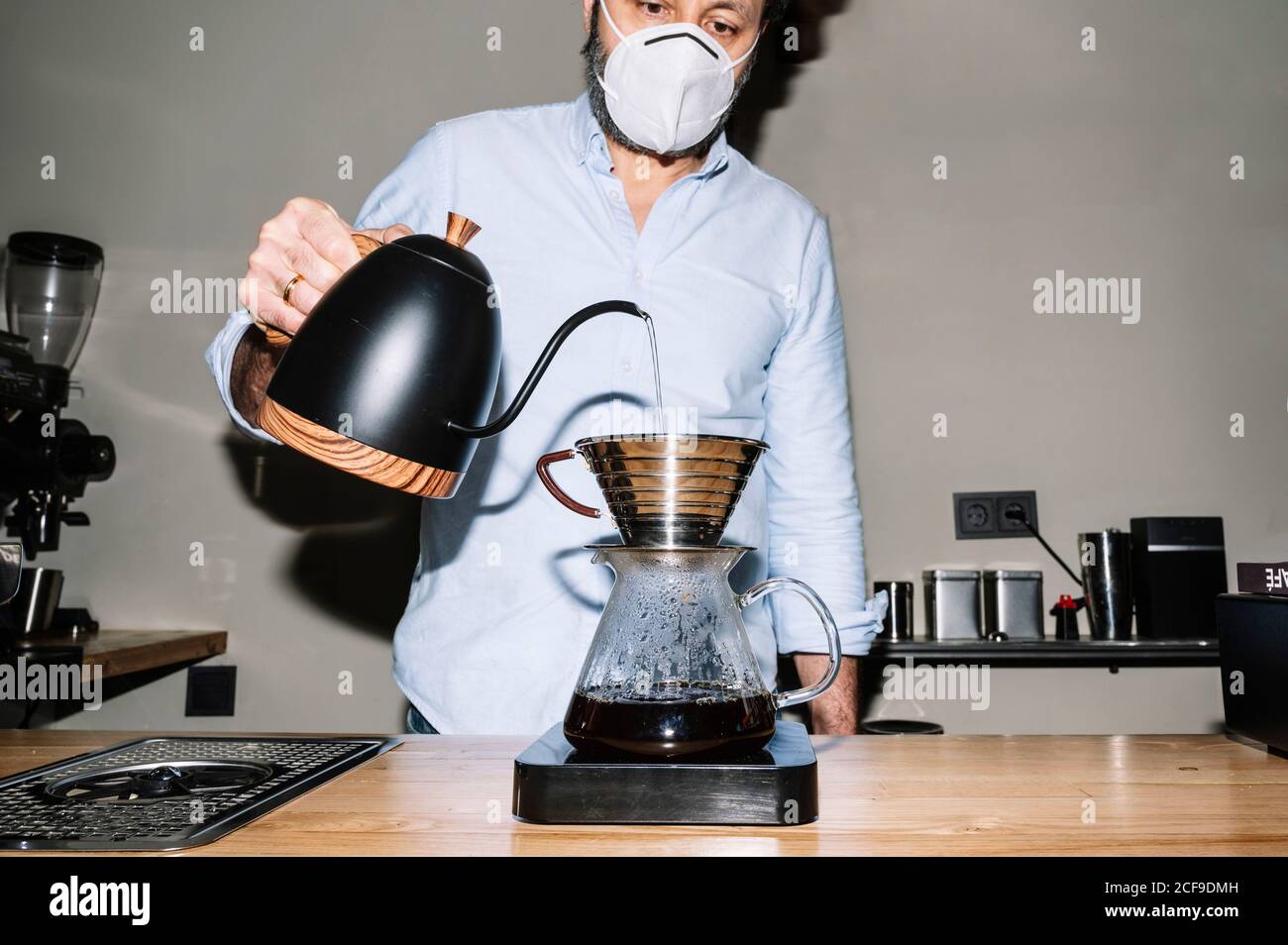 anonymous male barista standing near 