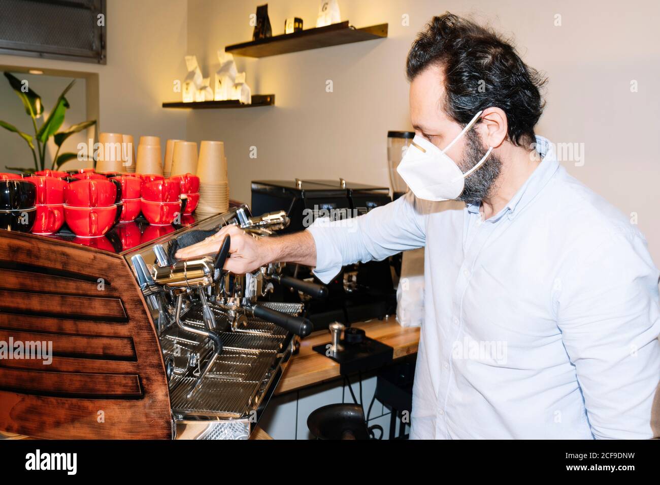 Side view of barista cleaning coffee machine in cafe Stock Photo Alamy