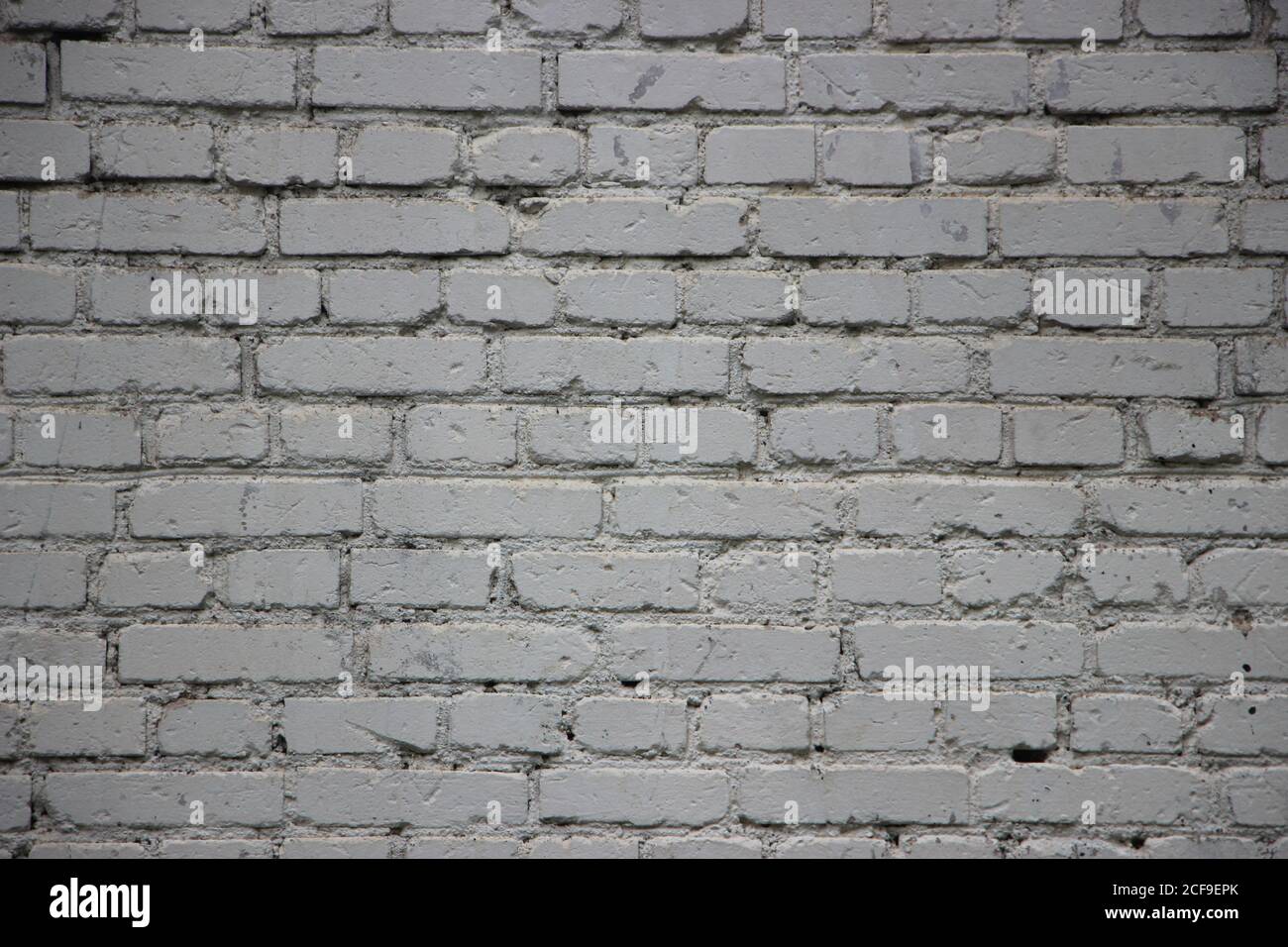 old grunge vintage brick wall painted into solid gray background texture Stock Photo