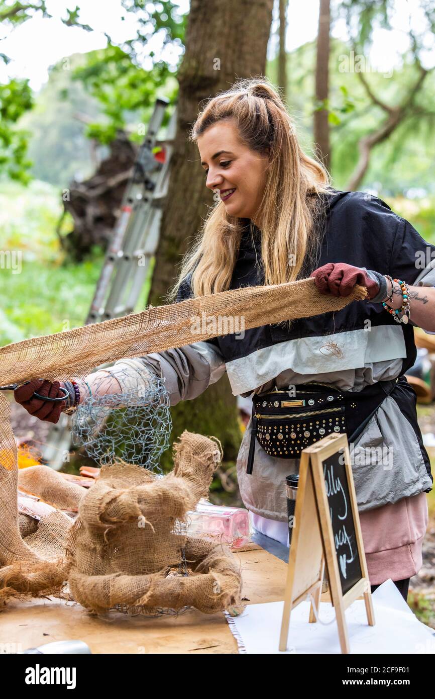 Monkey making creative nature art workshop at We Are Not a Festival socially distanced event in Pippingford Park - camping with a festival vibe Stock Photo