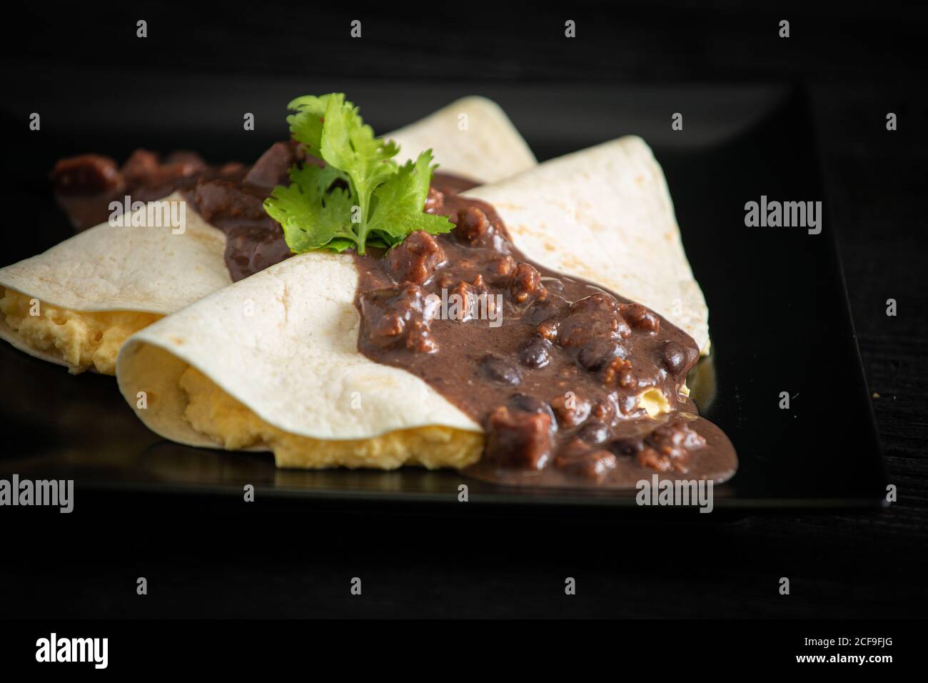 Veracruz eggs wrapped in tortillas decorated with sauce Stock Photo Alamy