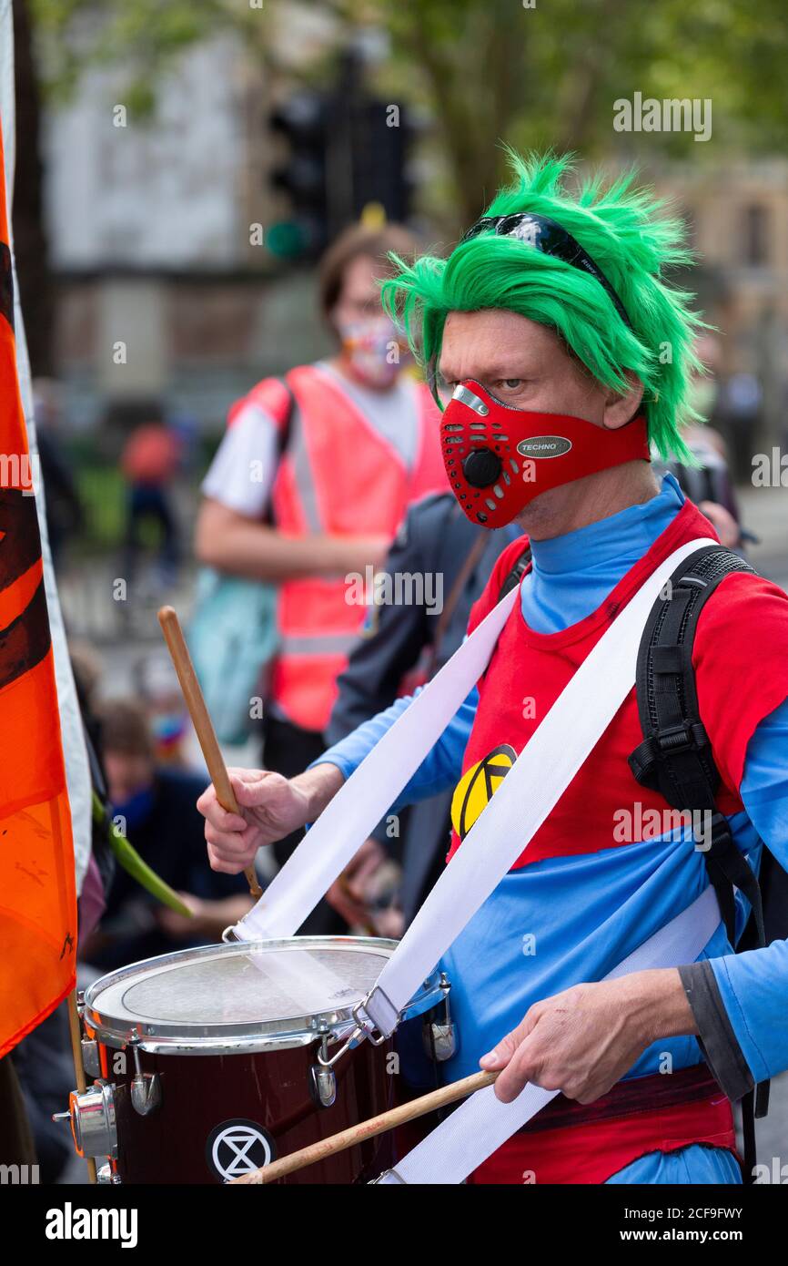 Drummer in costume, Extinction Rebellion demonstration, Parliament Square, London, 2 September 2020 Stock Photo
