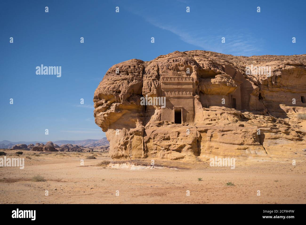 Picturesque scenery of tombs carved into sandstone cliffs as architecture and archeological site in Saudi Arabia Stock Photo