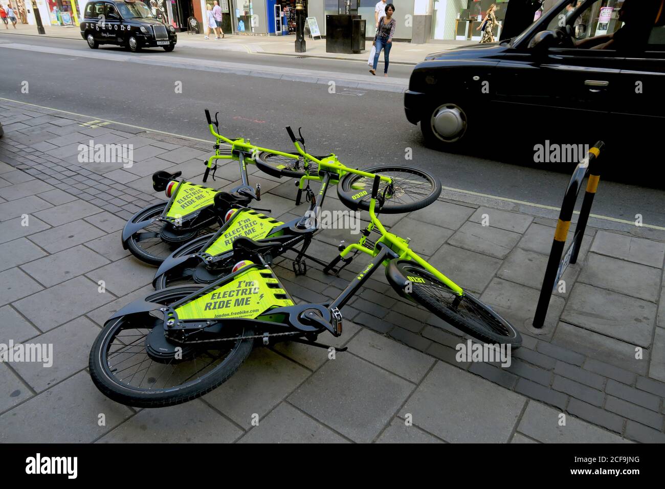 London Oxford St. 3 free rental electric bikes on the pavement Stock Photo