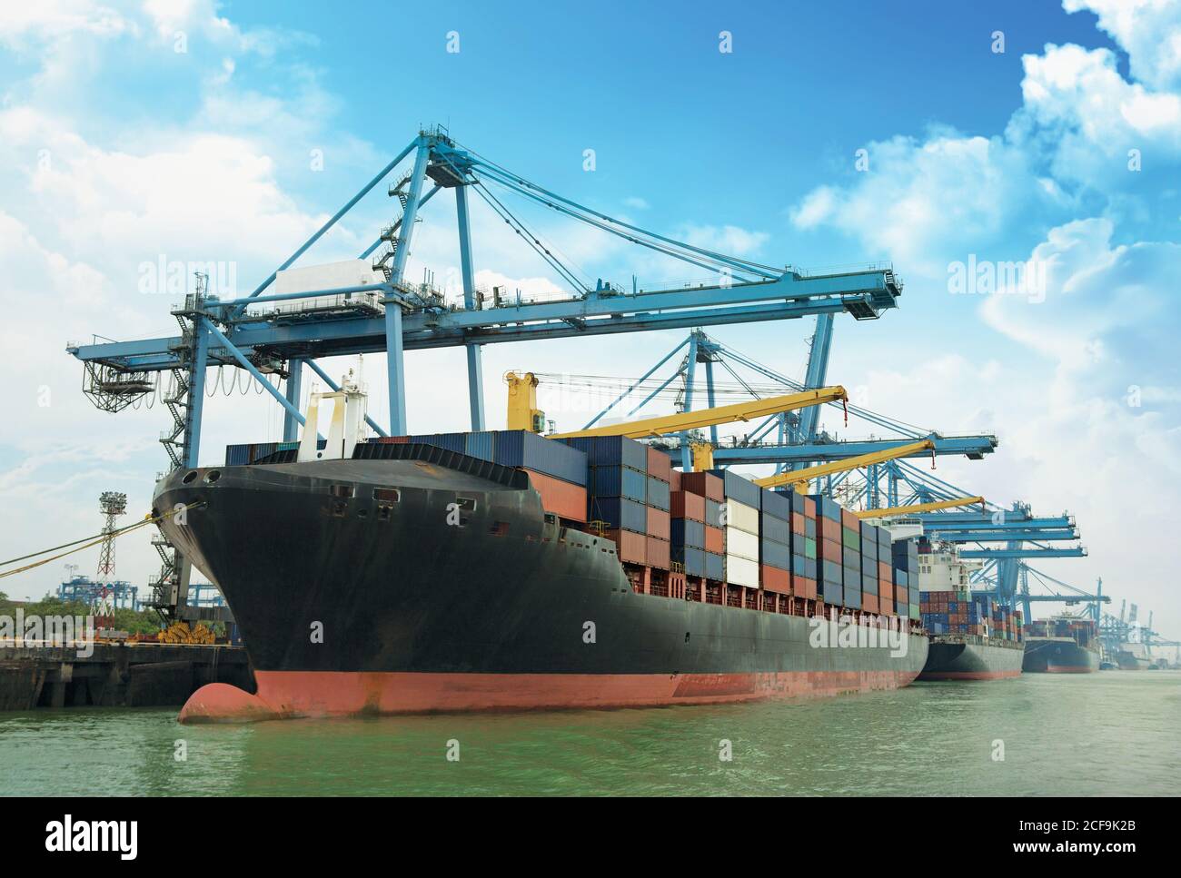 Cargo ship and container box over shipping dock Stock Photo