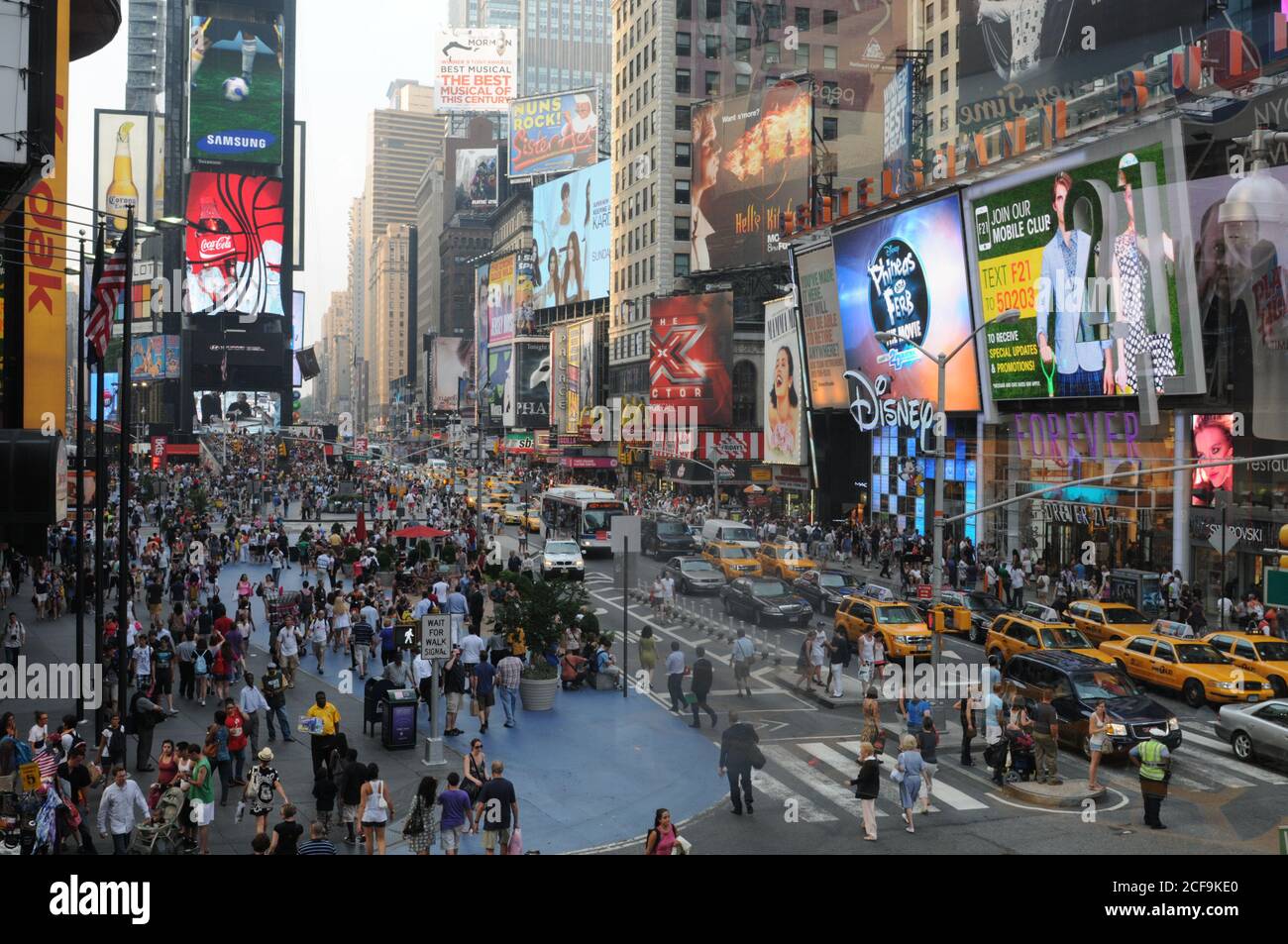 Crowd of people walking in the streets of Times Square in New York City USA Stock Photo