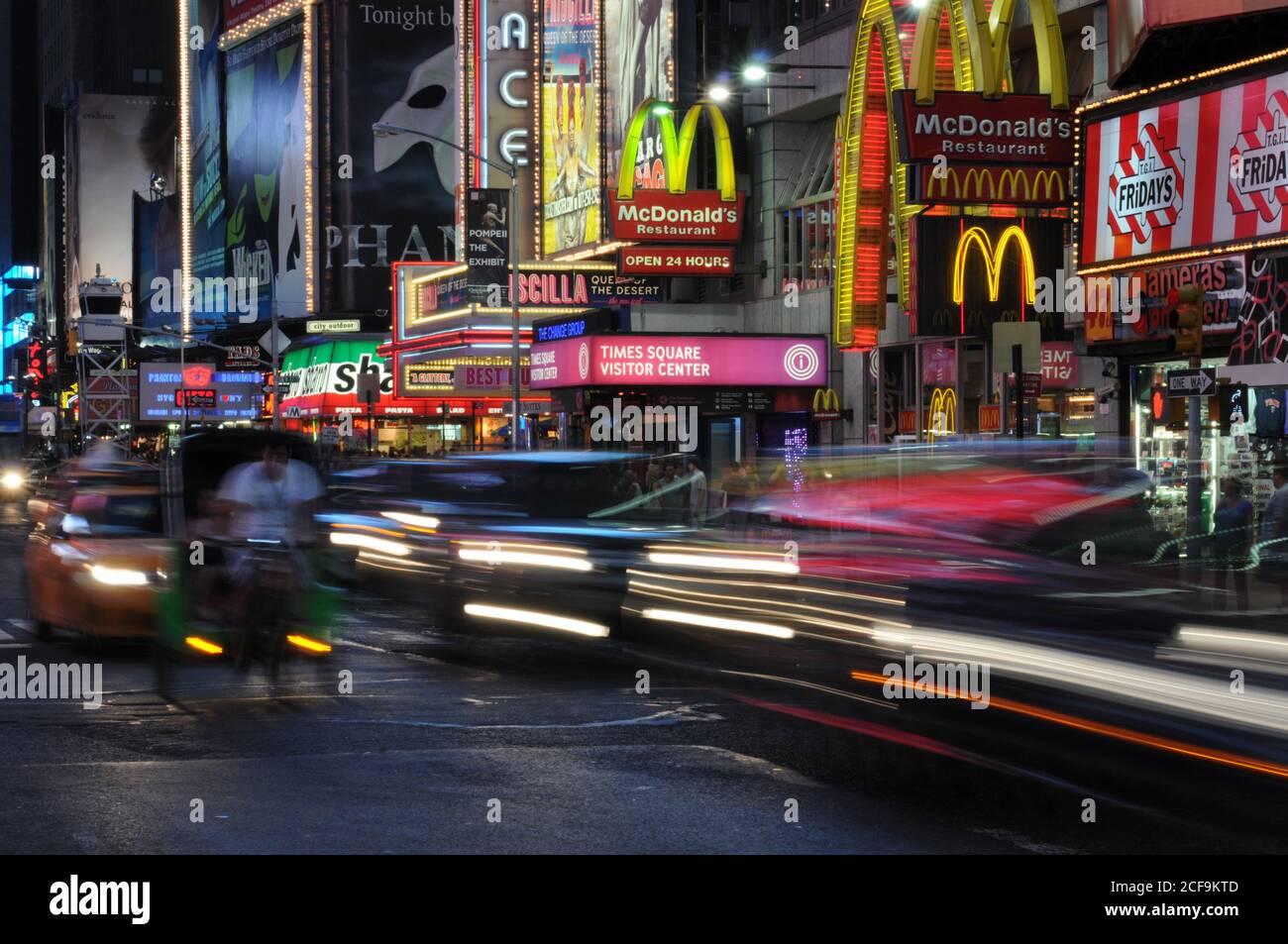 New York Times Square with illuminated billboards and moving cars, USA Stock Photo
