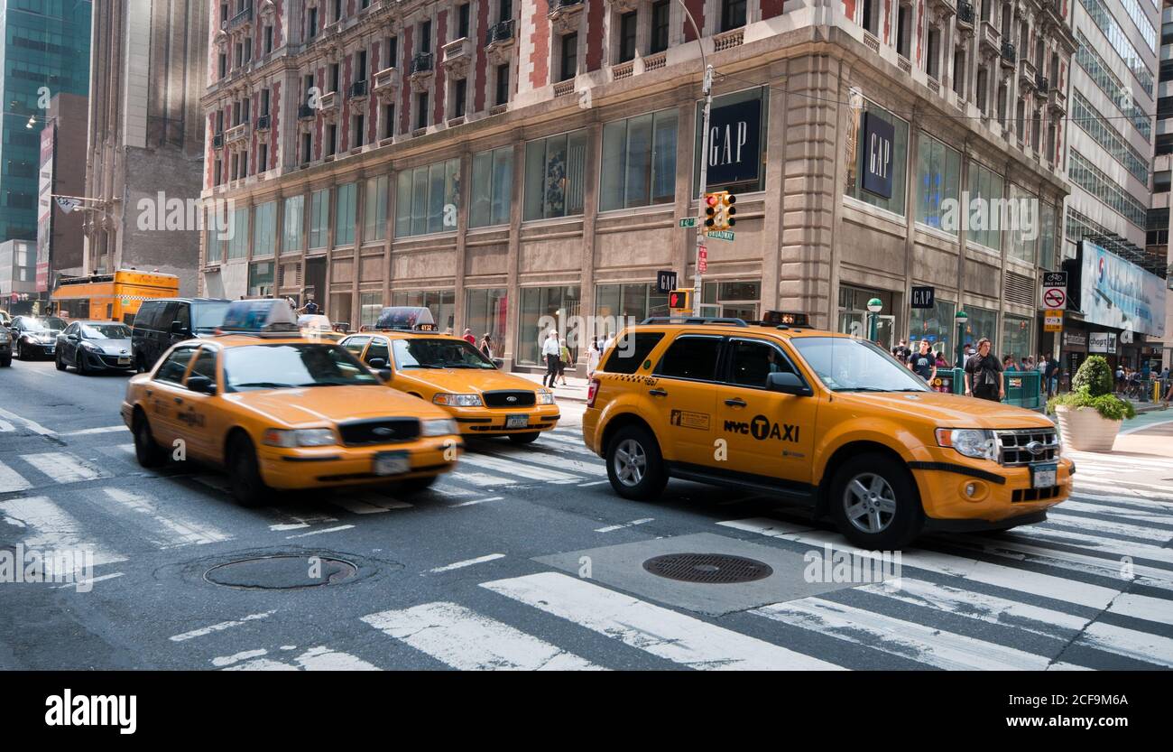 Midtown Manhattan street view with yellow taxis on the 5th avenue, New York, USA Stock Photo