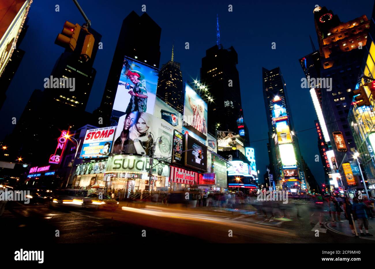 New York Times Square with illuminated billboards and moving people. Stock Photo