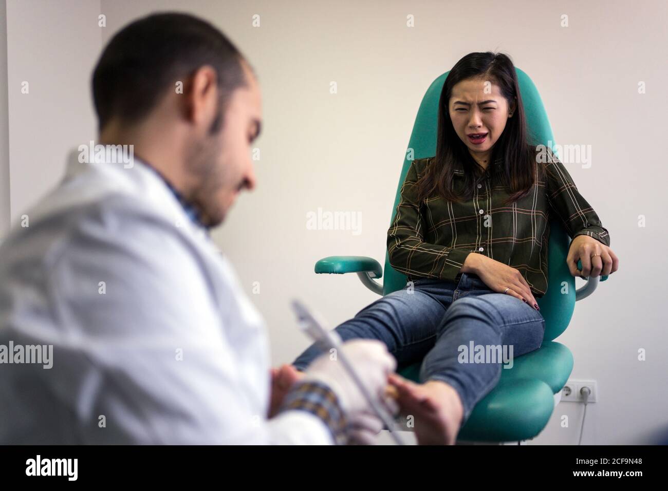 Podiatry doctor using ultrasound scanner Stock Photo