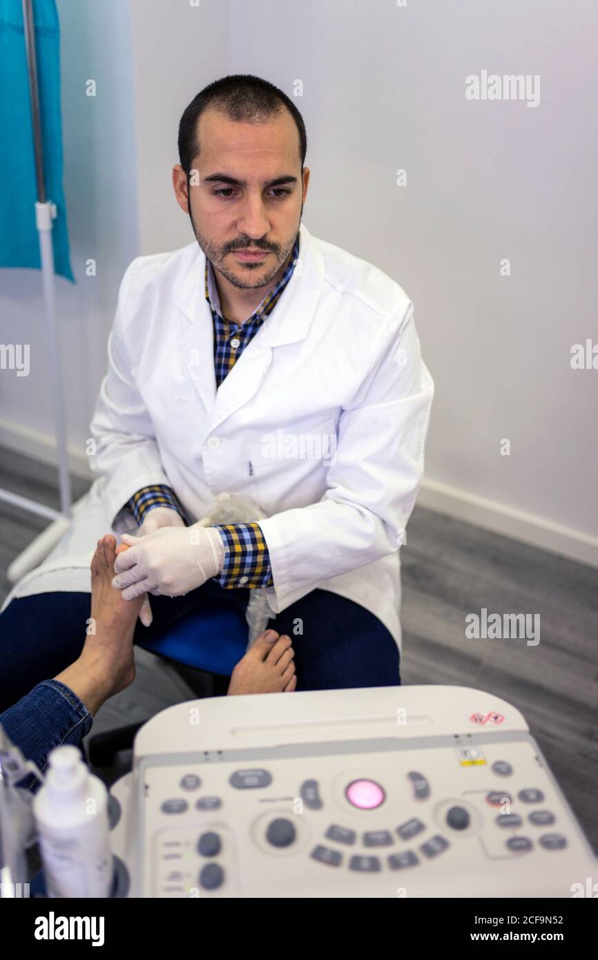 Podiatry doctor using ultrasound scanner Stock Photo