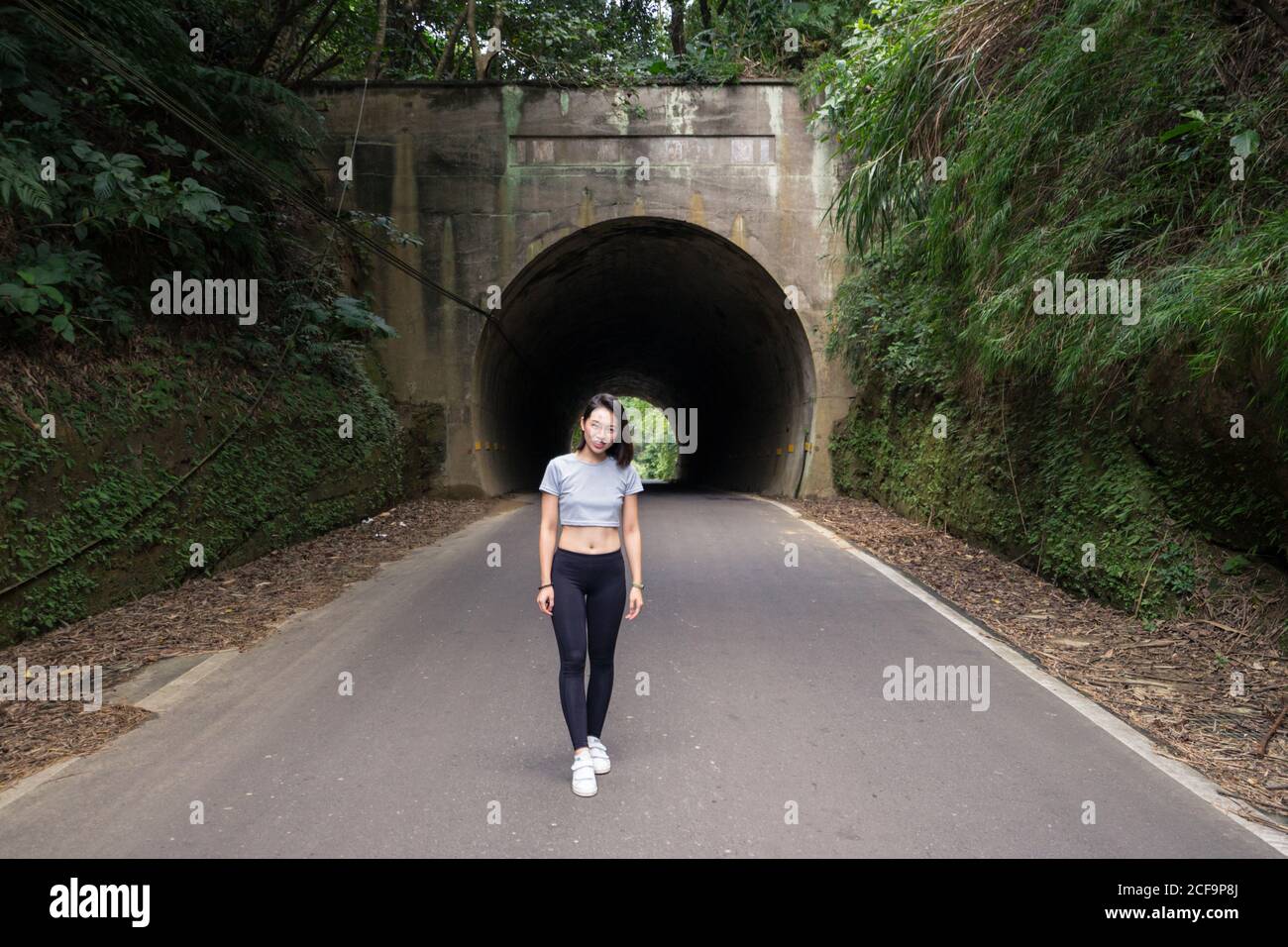 Satisfied female traveler during walk in countryside Stock Photo