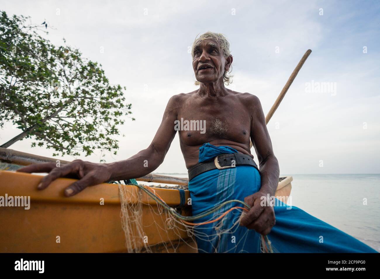 Tangalle, Sri Lanka - July 28, 2019: Ethnic old fishermen in