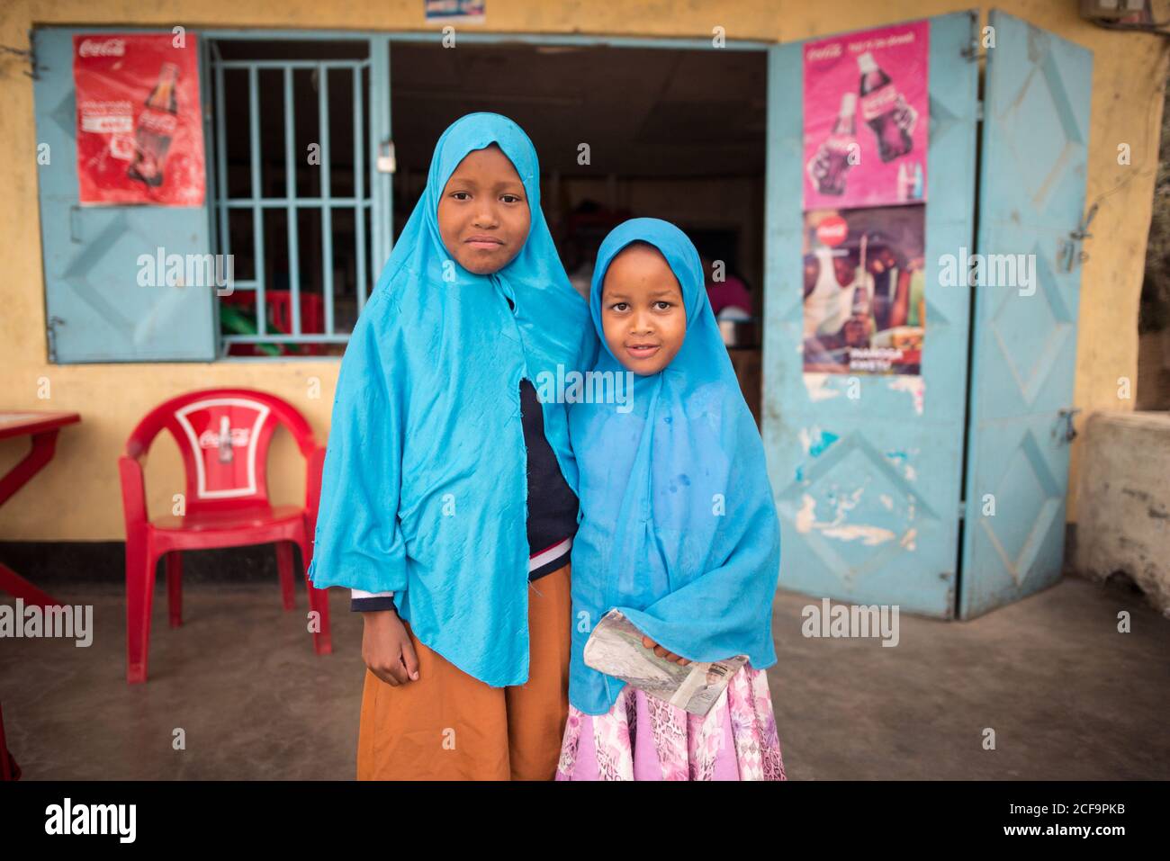 Tanzania, East Africa - November, 2016: Little African female local citizens  in blue muslim head scarfs smiling and looking at camera in Tanzania Stock  Photo - Alamy