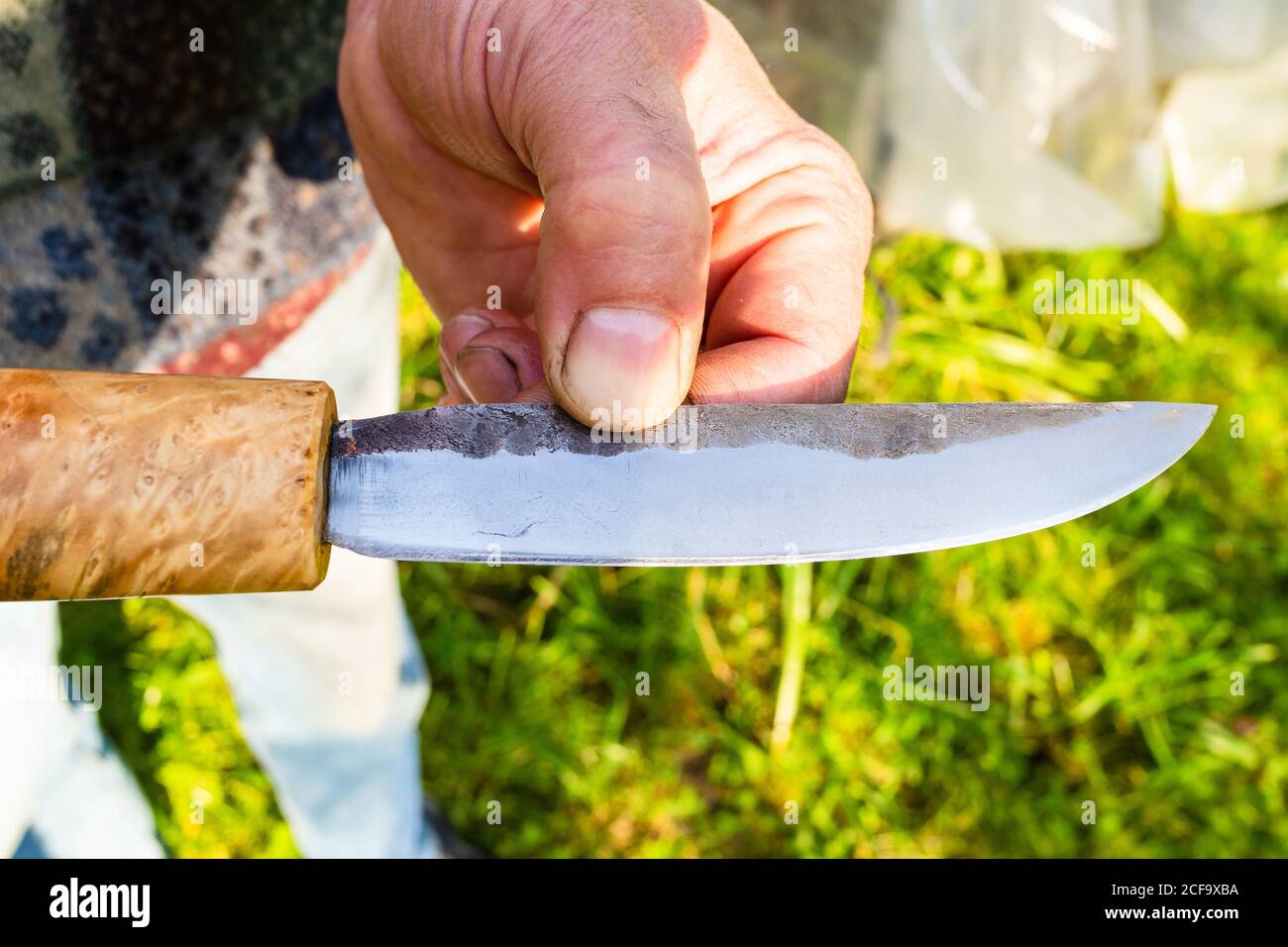 hand forged steel knife with wooden handle close up Stock Photo