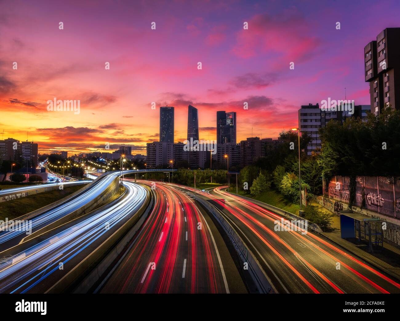 lækage Cirkel kort Drone view of cityscape with luminous highway in long exposure and  skyscrapers under sunset sky Stock Photo - Alamy