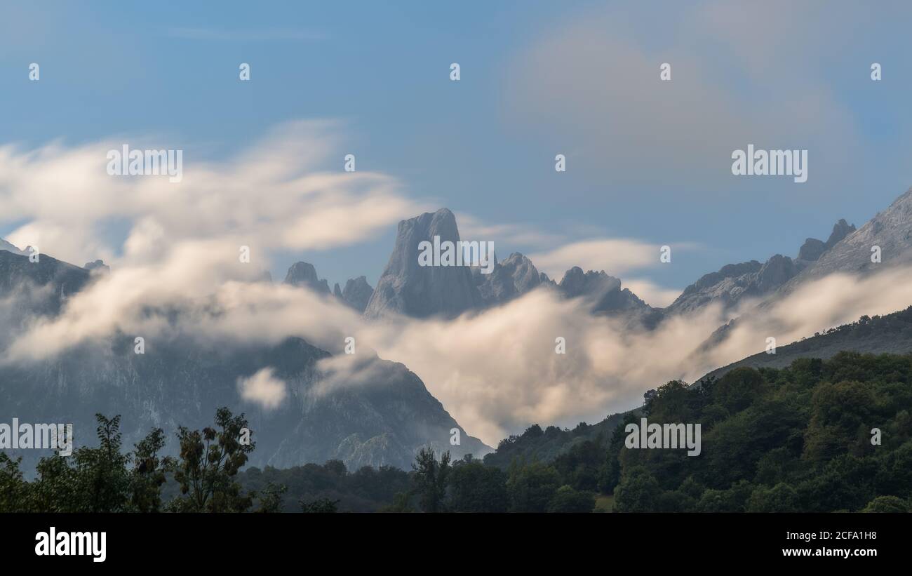 Majestic mountain range against cloudy sky during the day in nature Stock Photo