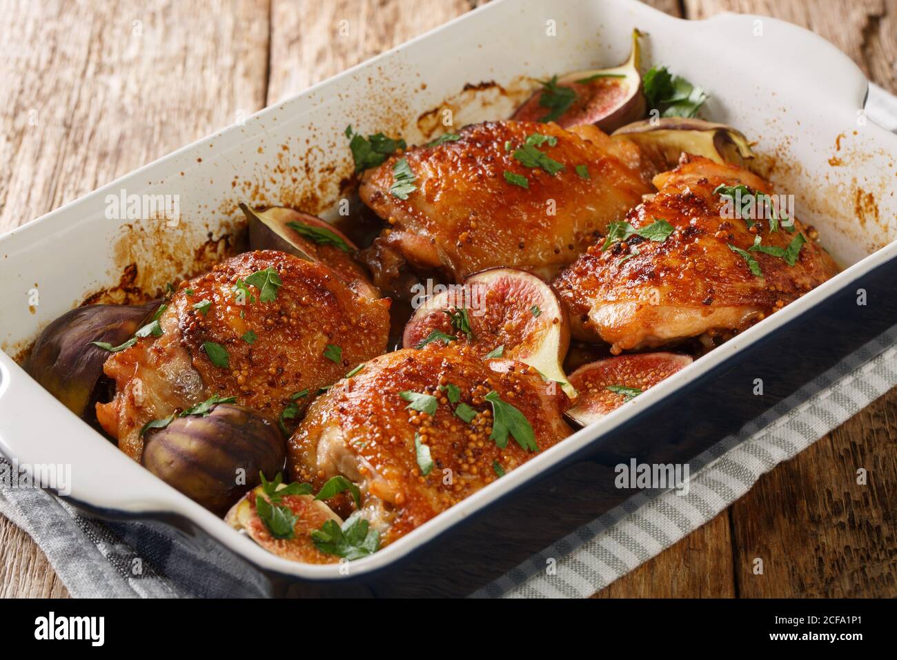 Honey Chicken Thighs Baked With Ripe Figs Mustard And Herbs Close Up In A Baking Dish On The Table Horizontal Stock Photo Alamy