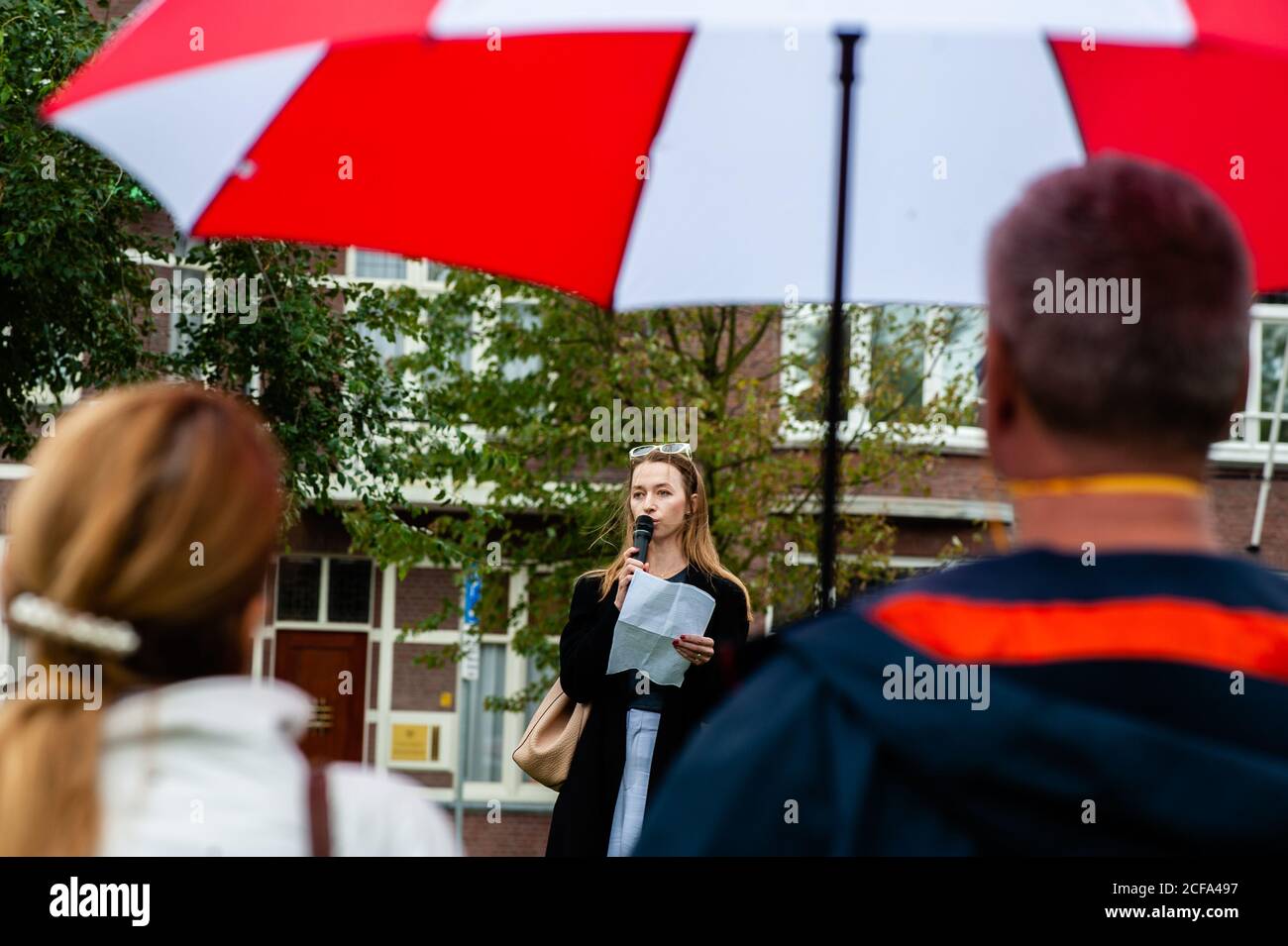 A Belorussian woman is seen giving a speech during the demonstration.While in Belarus a wave of strikes and workplace protests are adding pressure on Alexander Lukashenko to step down immediately. The Belarusian Congress of Democratic Trade Union (BKDP) which is one of the representative organizations of the Belarusian free trade unions is calling on the international trade union movement and other sympathizers to peacefully protest at the Belarusian embassies around the world. In The Hague, the FNV, the largest trade union in the Netherlands organized a protest in front of the Belarusian Emba Stock Photo
