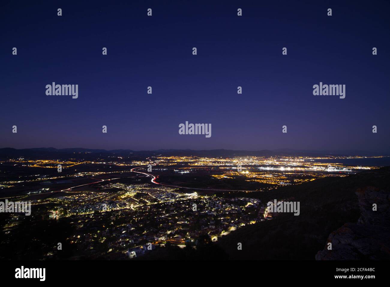 Beautiful cityscape view with city lights under a clear night sky Stock