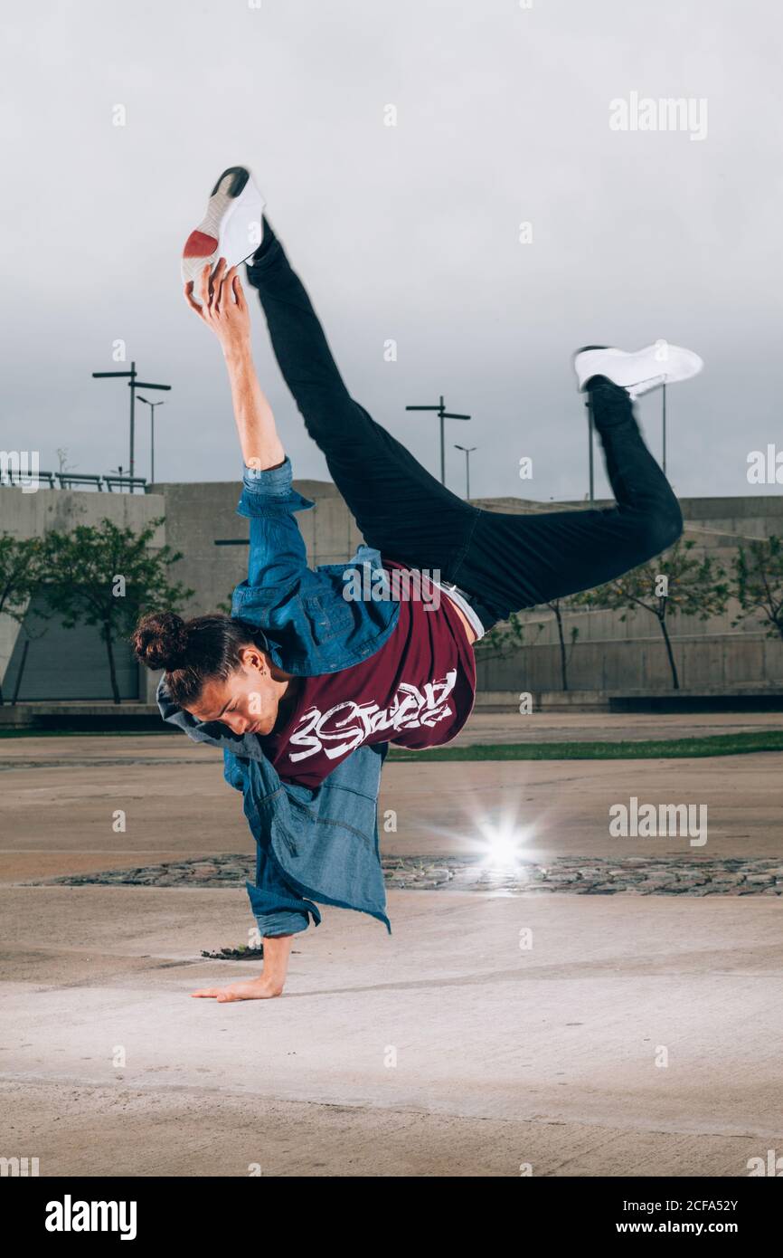 Skillful break dancer performing handstand while moving Stock Photo - Alamy