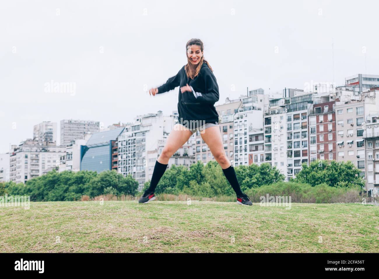 SportsWoman practicing yoga on lawn Stock Photo