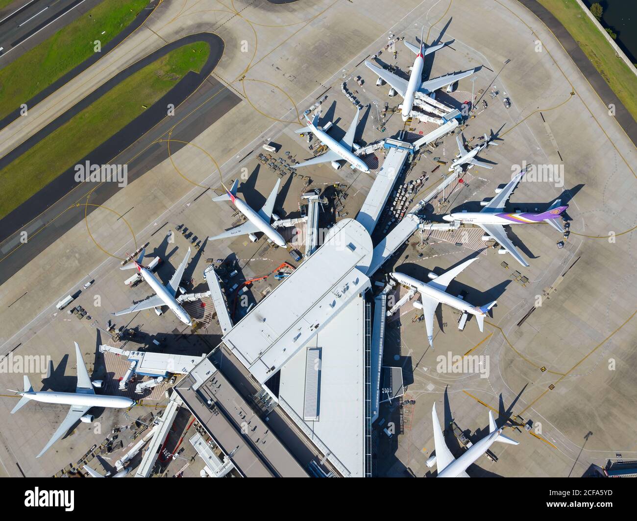 Sydney Airport aerial view with international Passengers Terminal 1 busy with international flights. Kingsford Smith International Airport, Australia. Stock Photo