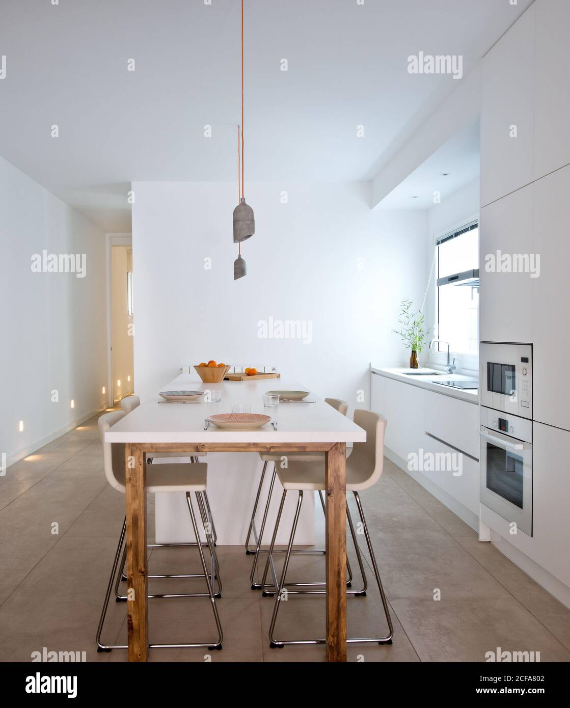 Interior Of Contemporary Kitchen In Scandinavian Style With Dining Table And Bar Stools Stock Photo Alamy