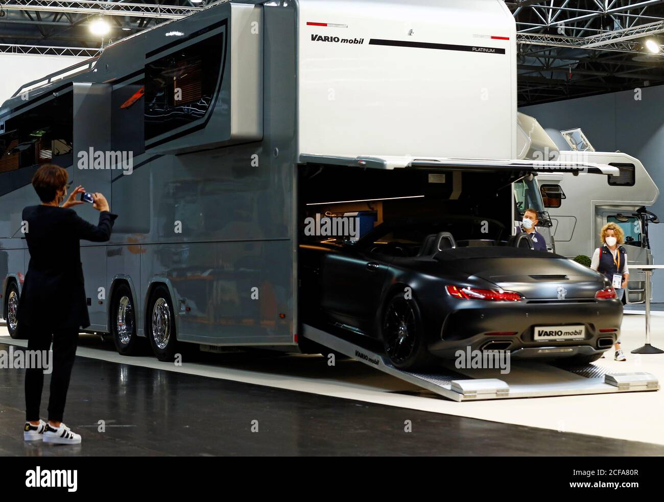 People watch the motorhome "Vario Perfect 1200 Platinum" of German motorhome  maker Variomobil at the consumer trade fair "Caravan Salon" for caravans,  motorhomes and camping, which is one of the first fairs