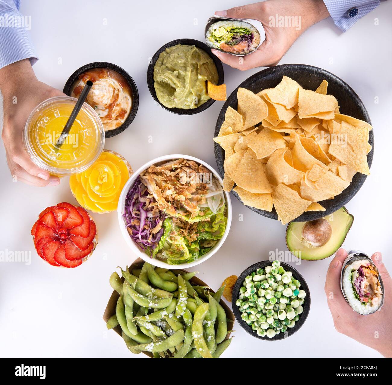 Top view of crop anonymous people eating various types of traditional