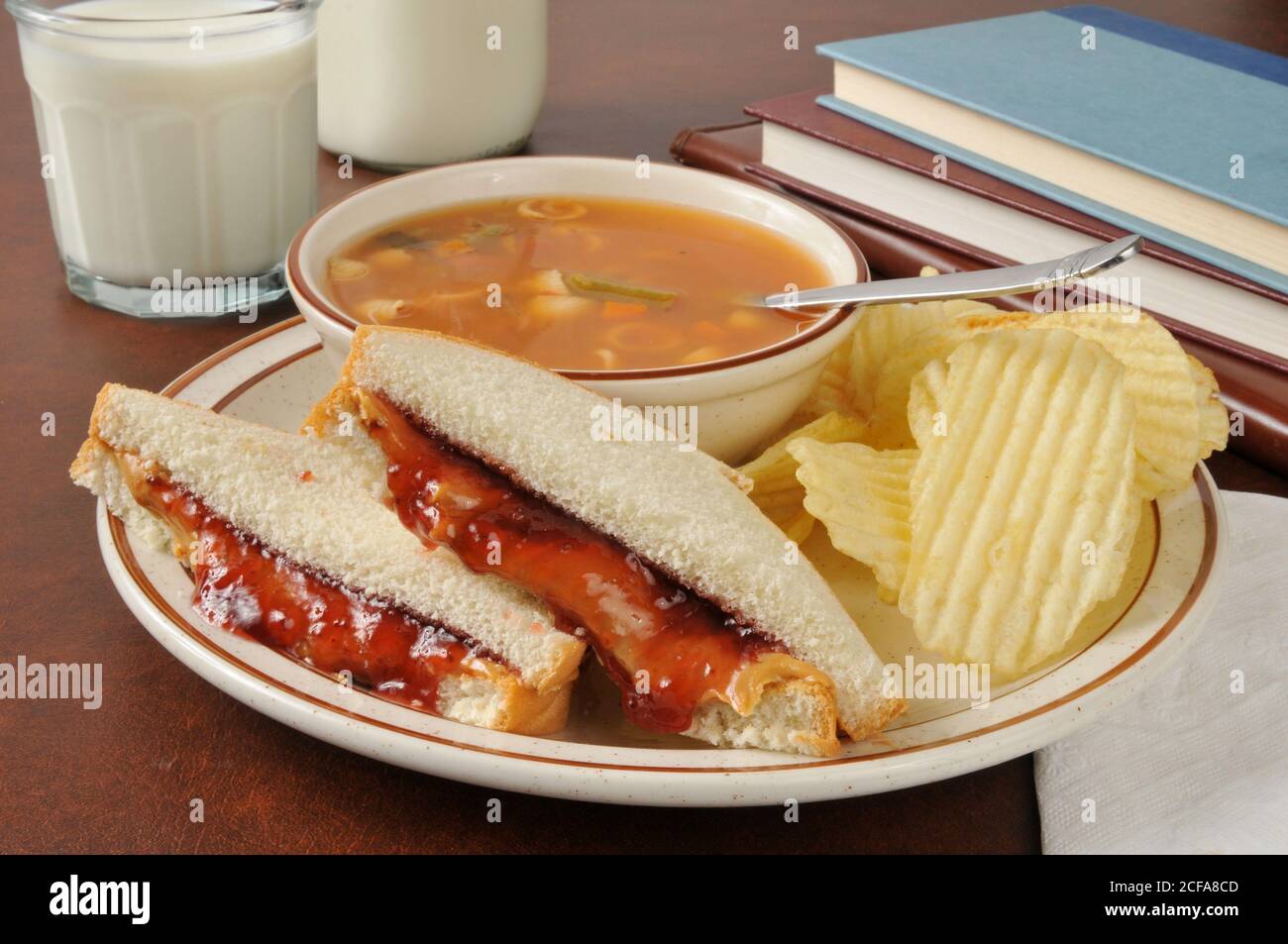 A peanut butter and jelly sandwich with vegetable beef soup near school