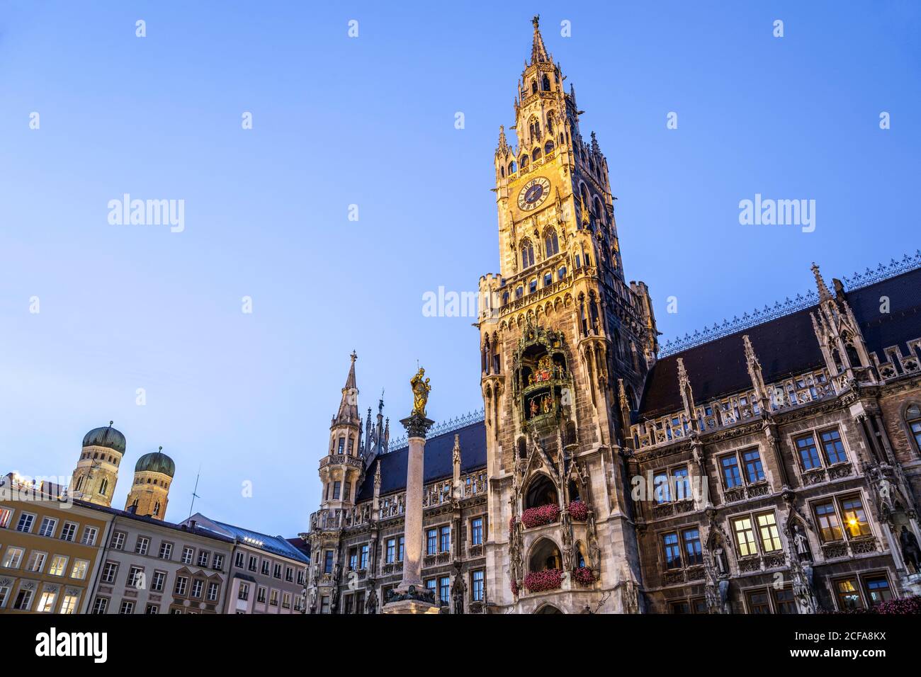 New Town Hall (featuring clock tower and Glockenspiel), domed towers of Frauenkirche (left), Marienplatz, Munich, Germany Stock Photo