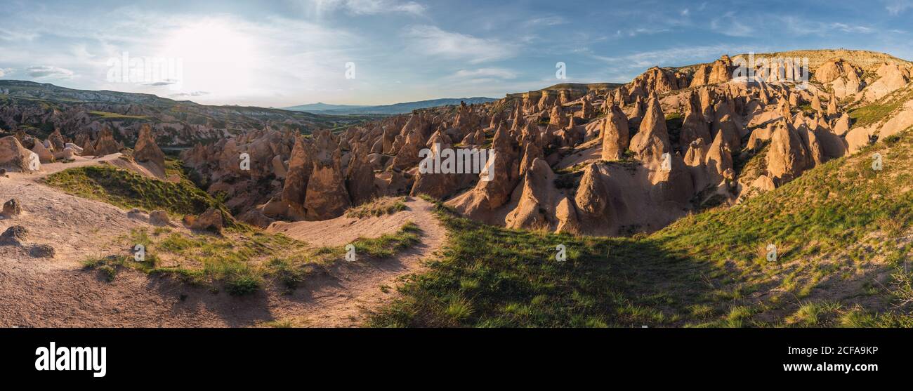 Rough stone formations located in wonderful valley on sunny day in Cappadocia, Turkey Stock Photo
