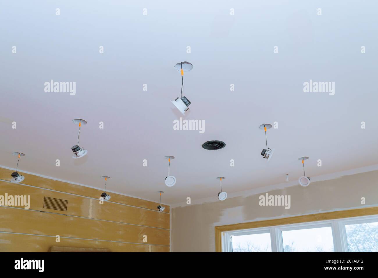 Close-up a hand changes a light LED in a stylish preparations for ceiling lamp interior lighting installation Stock Photo