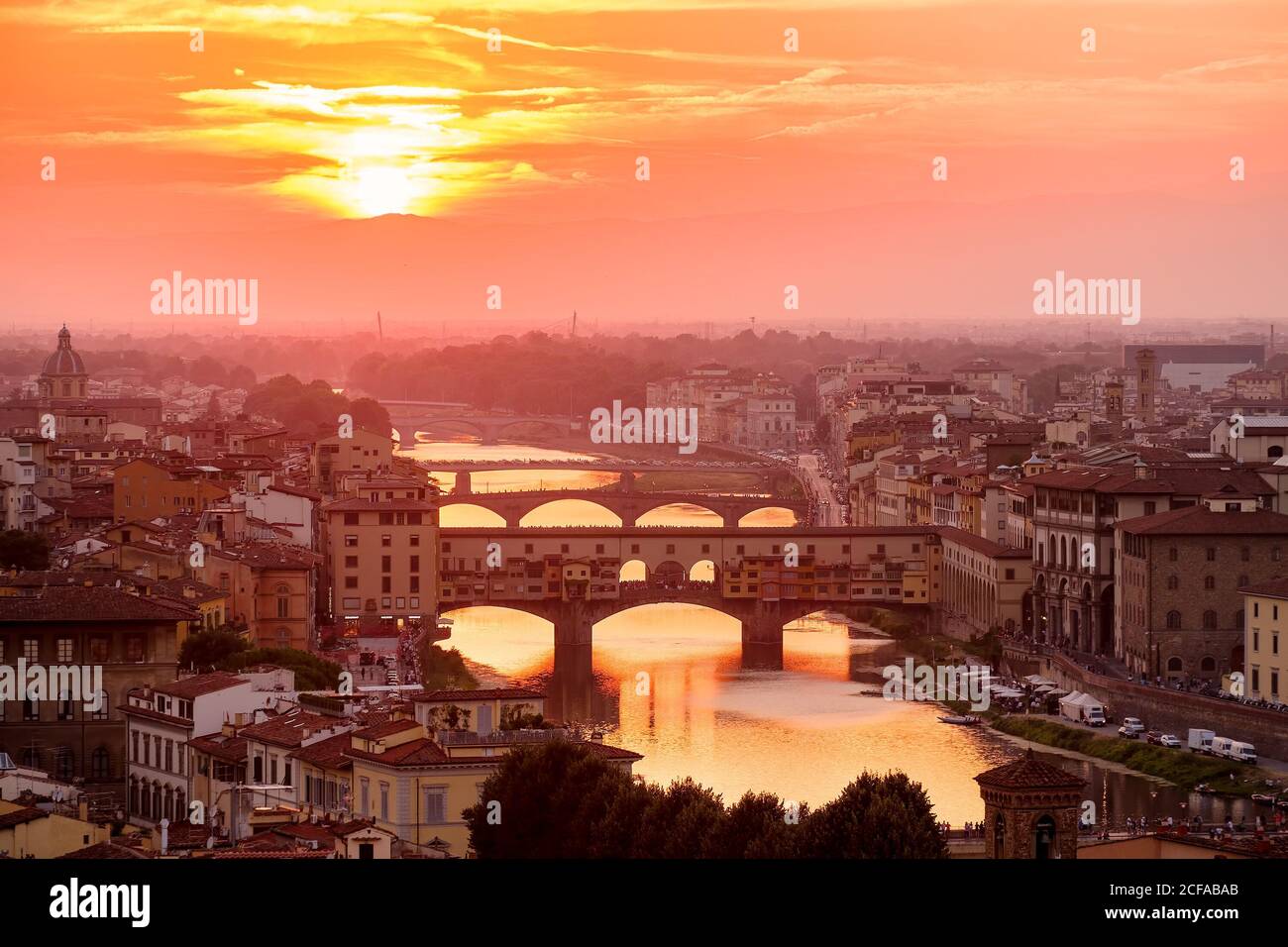 Beautiful sunset at the medieval city of Florence with a view of the Ponte Vecchio and the river Arno Stock Photo