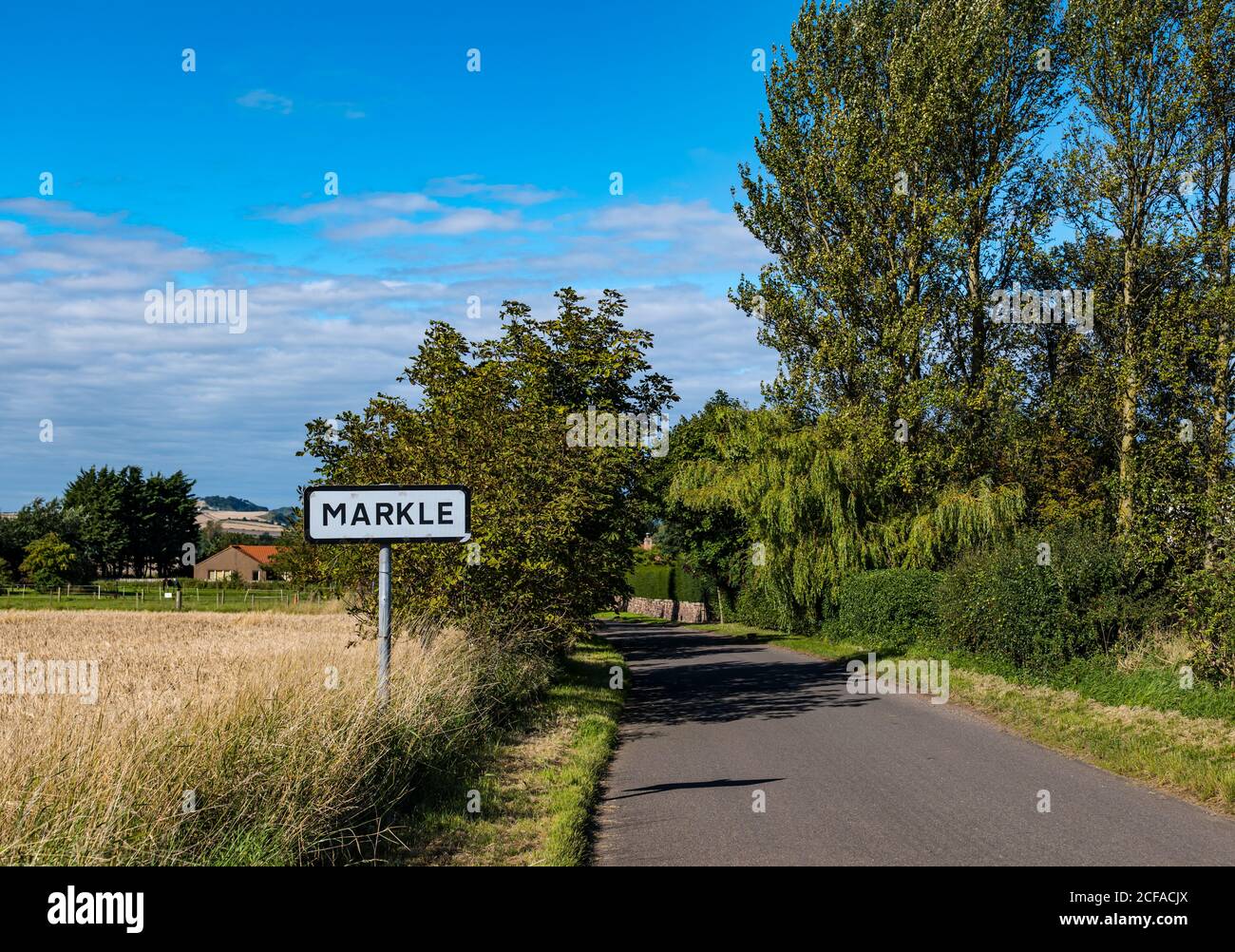 Quiet empty country road with village sign, Markle, East Lothian, Scotland, UK Stock Photo