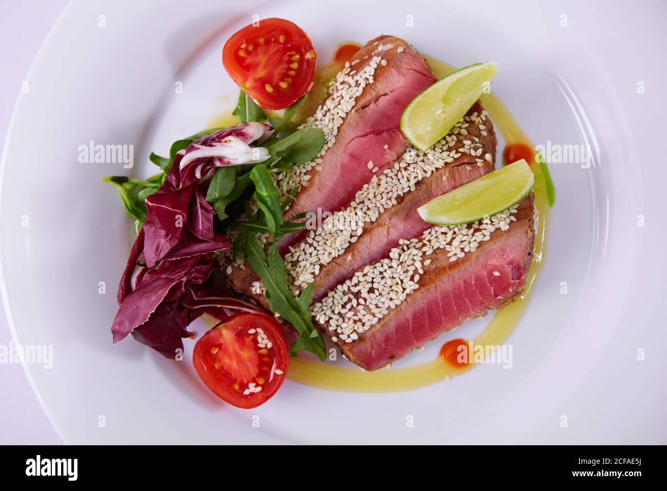 Close up of Ahi Tuna Steak Sprinkled with White Sesame Seeds. Shallow dof Stock Photo