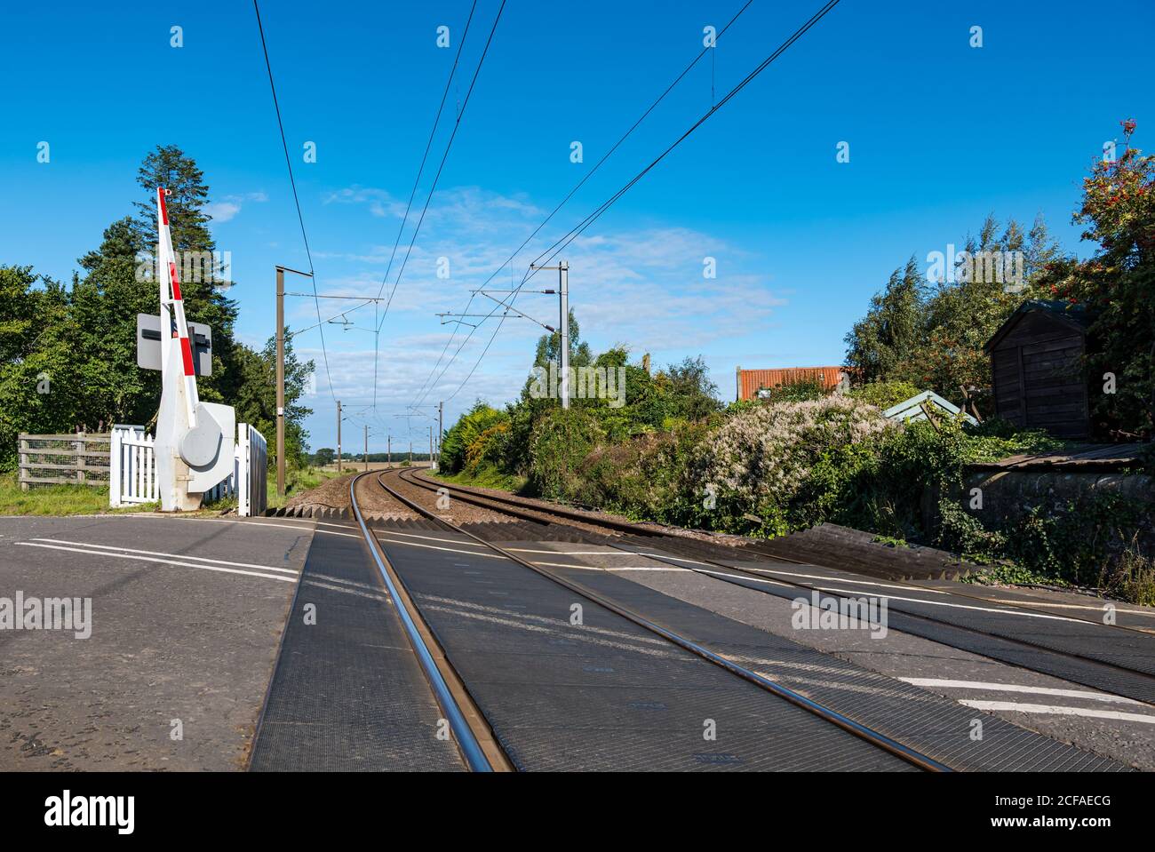 View along tracks at East Coast mainline  railway line level crossing, Markle, East Lothian, Scotland, UK Stock Photo