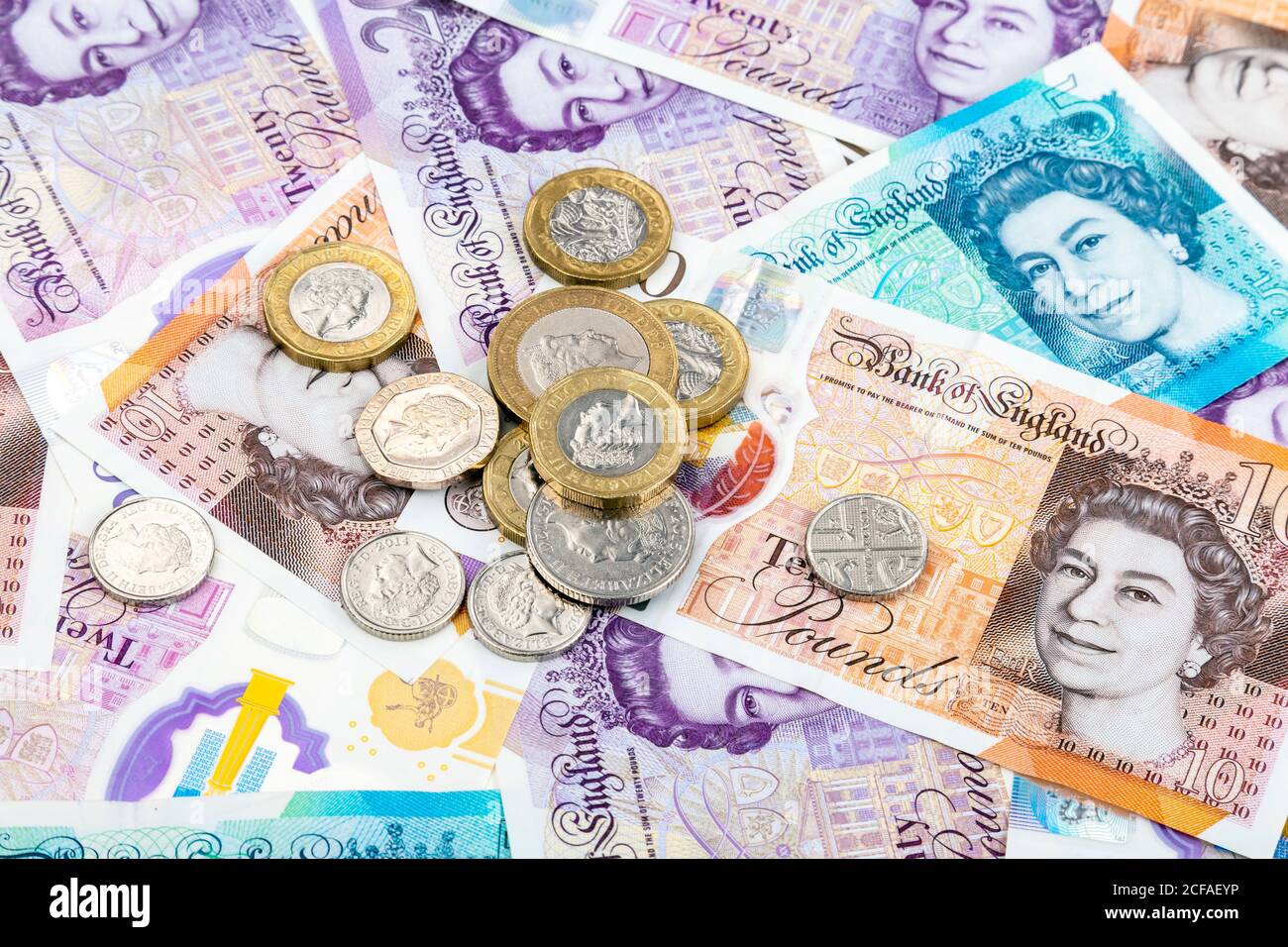 New British pound polymer notes and coins scattered Stock Photo