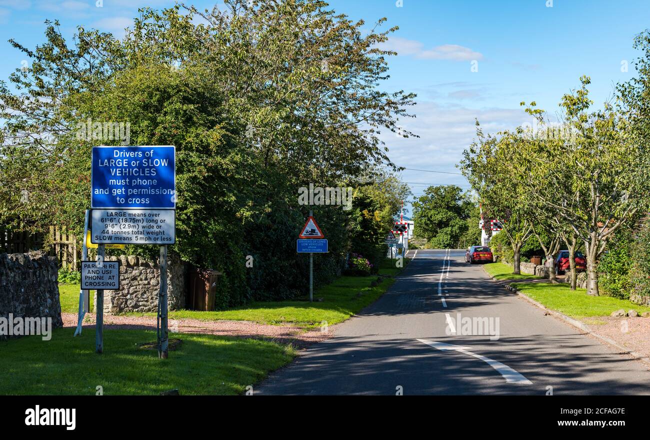 Warning road sign at East Coast mainline railway line level crossing