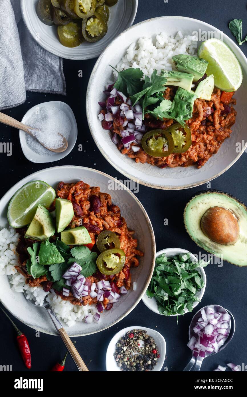 Served chili with rice and vegetables on table Stock Photo