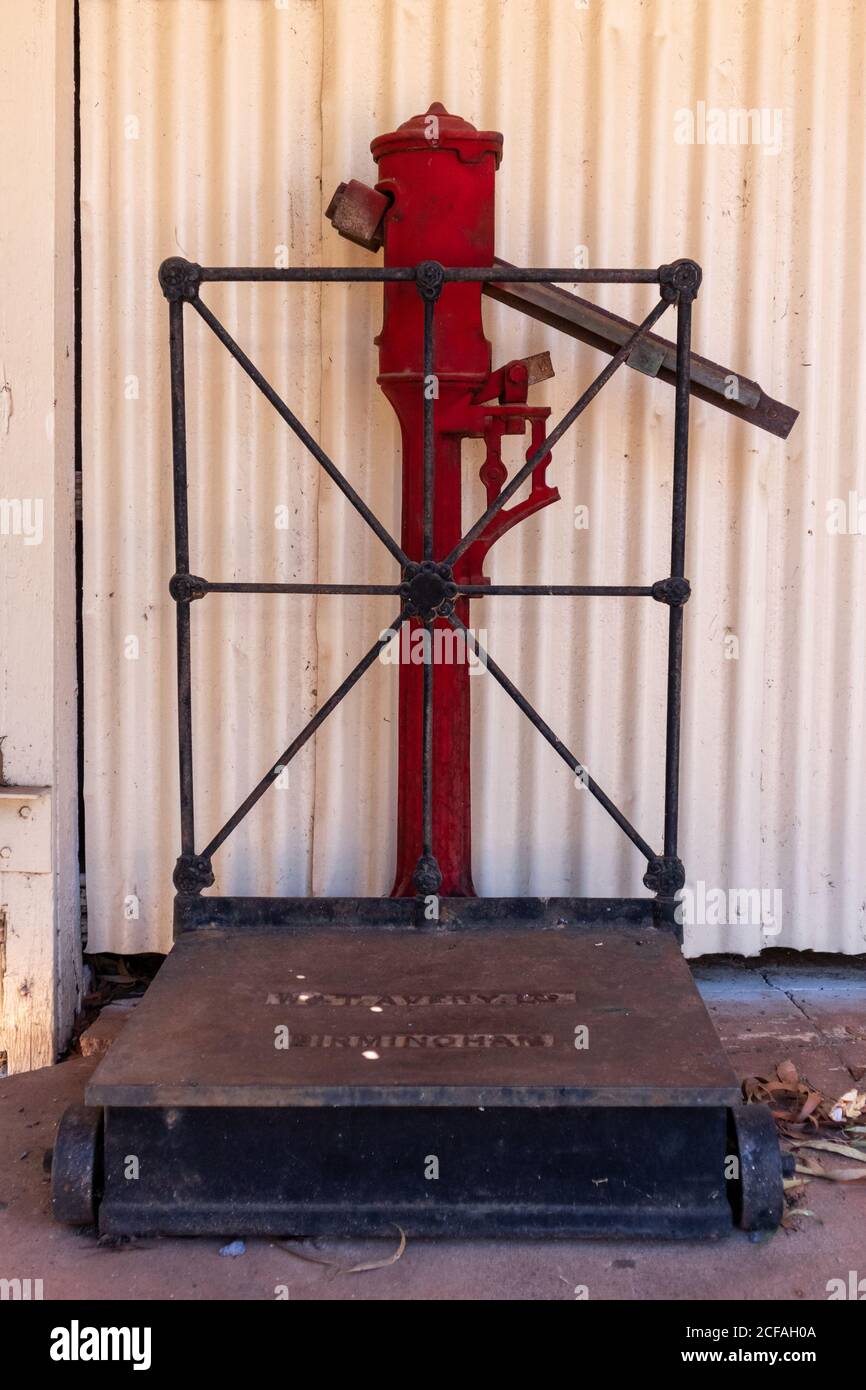 Vintage scale to weight luggage and people. Red color. Found at the old train station, Pine Creek, Stuart highway, Northern Territory NT, Australia Stock Photo