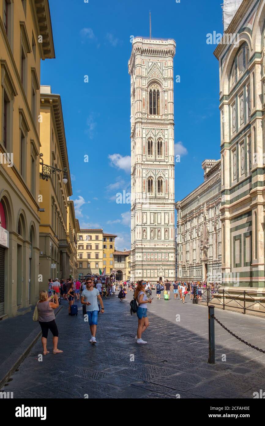 FLORENCE,ITALY - JULY 24,2017 : Tourists and locals at Piazza del Duomo in Florence with a view of the Campanile by Giotto Stock Photo