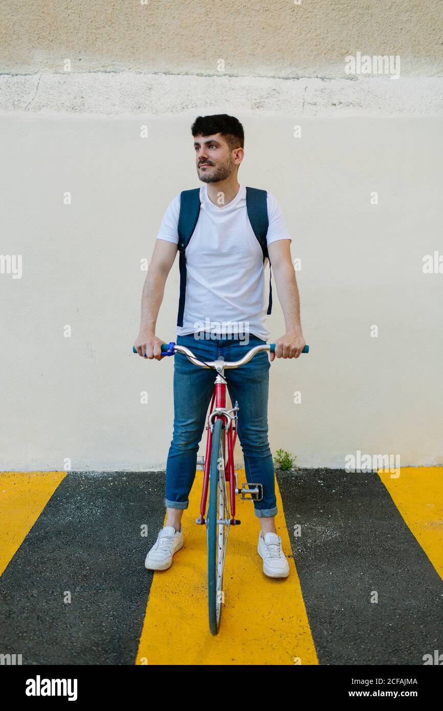 Front view of a young man riding a bike Stock Photo - Alamy