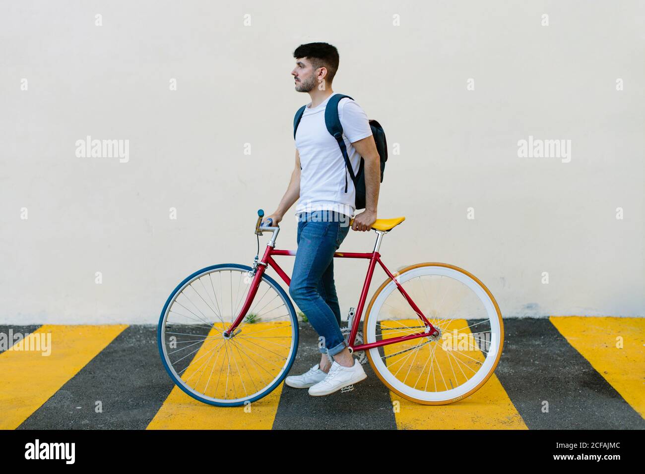 Side view of a caucasian man riding a fixie Stock Photo