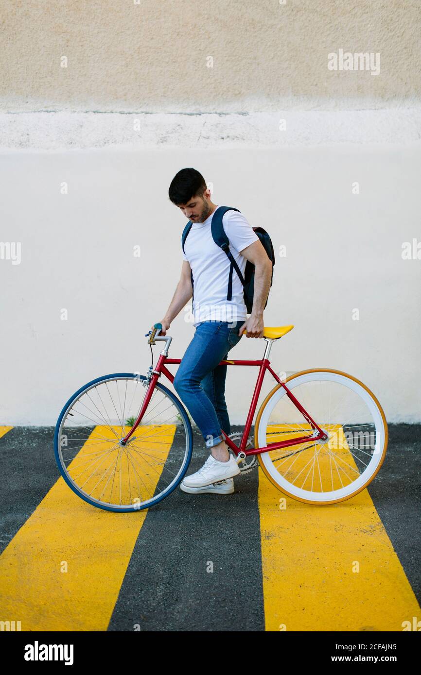 Side view of a young man with a fixie bike Stock Photo