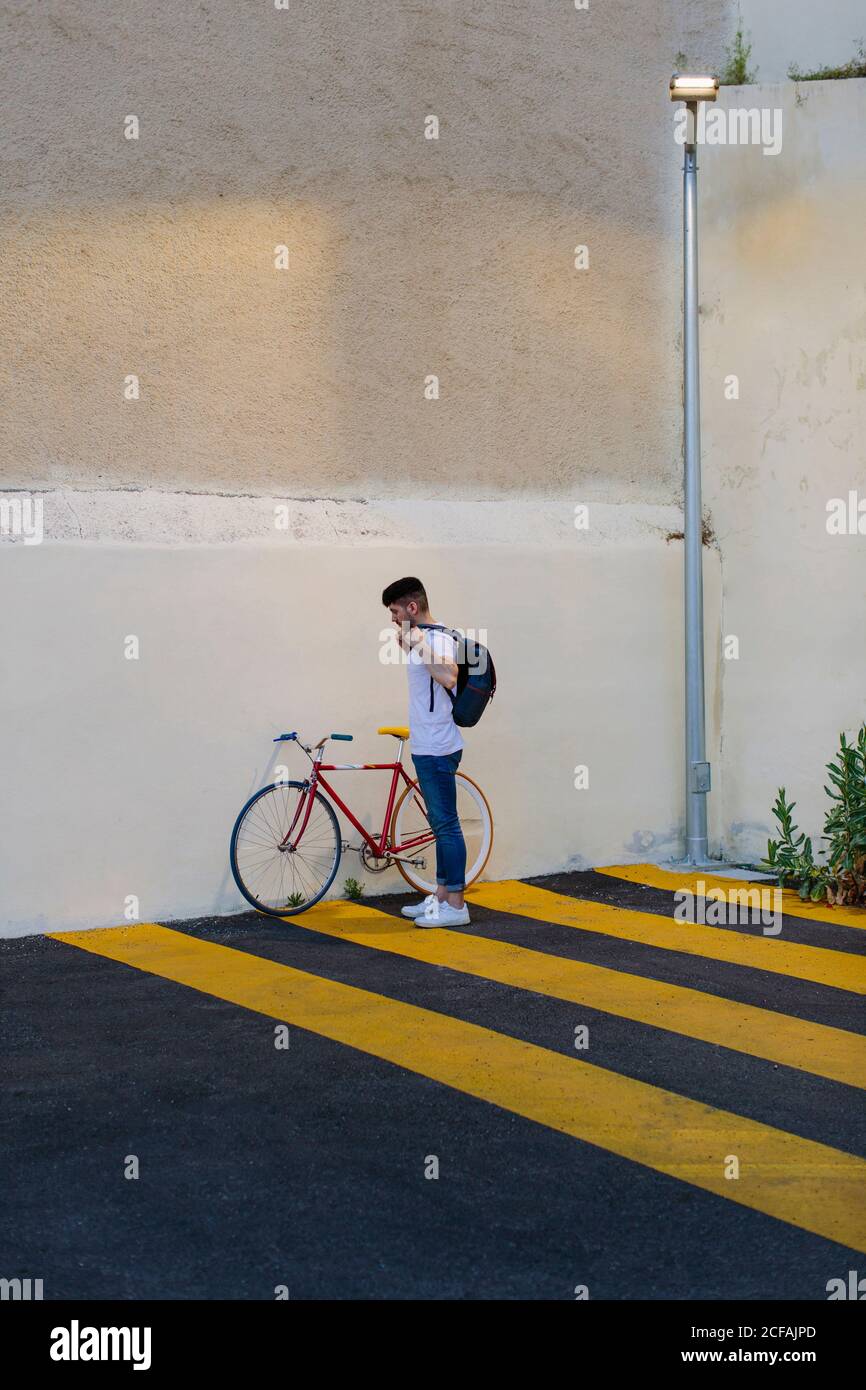 Caucasian male taking his backpack for riding a fixie bike Stock Photo