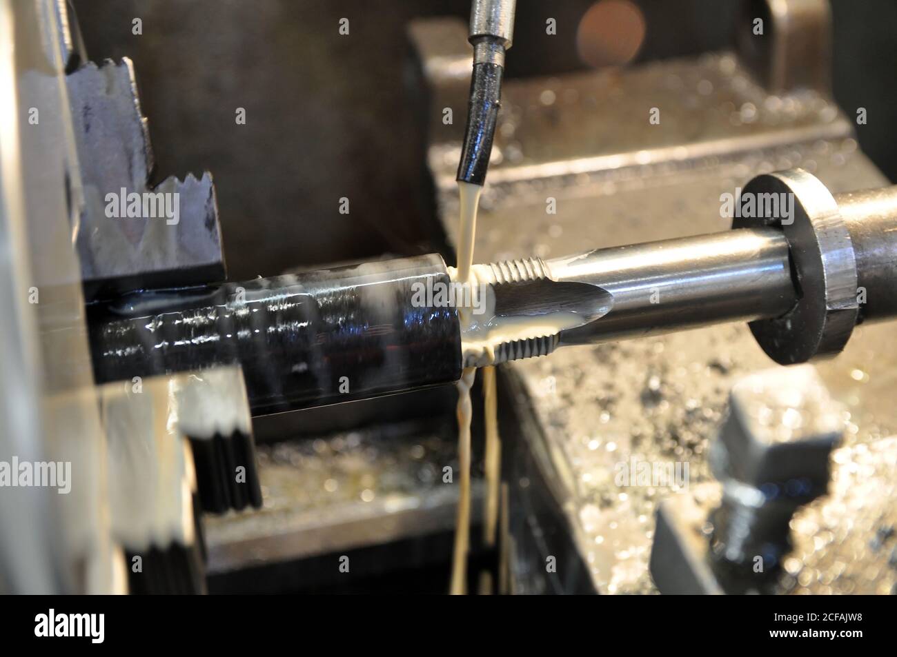 Metalworking machine at work. Lubricating and cooling fluid Stock Photo